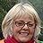 A close up of a woman wearing glasses and a red scarf.